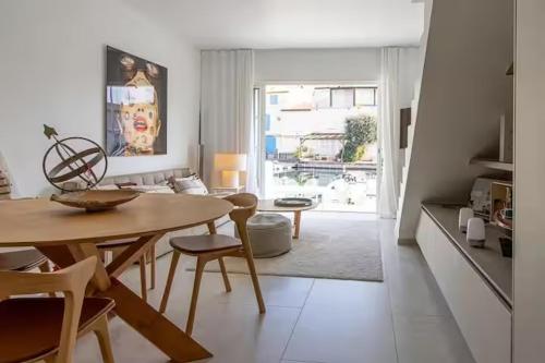 a living room with a table and a dining room at Balandrine in Grimaud