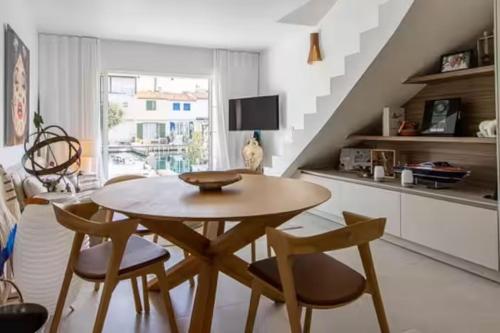 a table and chairs in a living room with a staircase at Balandrine in Grimaud