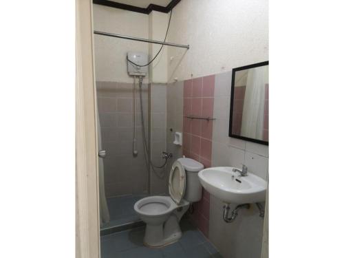 a bathroom with a shower and a toilet and a sink at OYO 880 Flores De Musa Inn in Puerto Princesa City