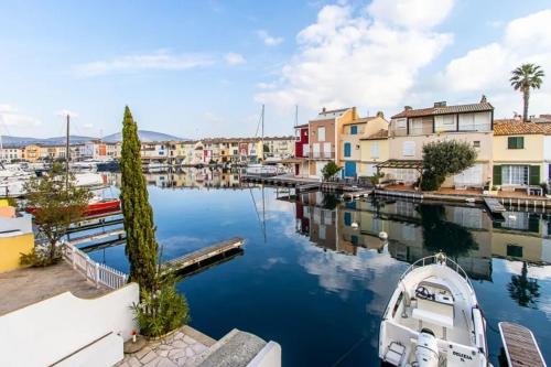 a boat is docked in a marina with buildings at Balandrine in Grimaud