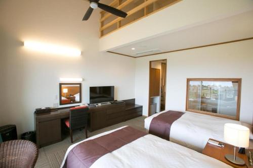Ένα ή περισσότερα κρεβάτια σε δωμάτιο στο Sakura Resort Hotel Ishigaki