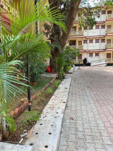 a cobblestone street in front of a building at Candolim Beach Apartments Goa in Candolim