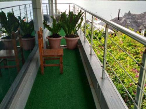 a balcony with a chair and potted plants on it at Crystal Palace Hotel in Port Vila