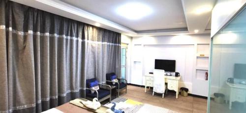 a room with a bed and a desk and a television at Crystal Palace Hotel in Port Vila