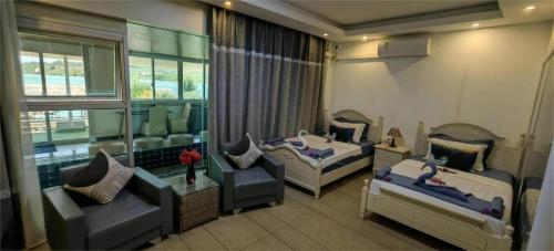 a living room with two beds and a couch at Crystal Palace Hotel in Port Vila