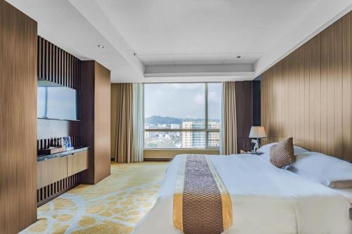Ένα ή περισσότερα κρεβάτια σε δωμάτιο στο Santavan Hotel Shenzhen Guangming