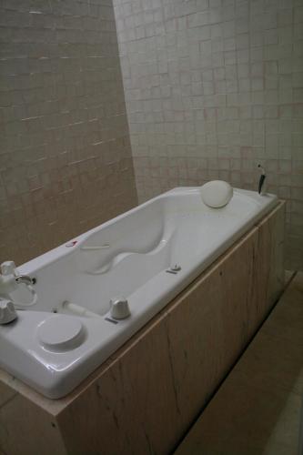a bathroom with a bath tub with a sink at Hotel Porto Santo & Spa in Porto Santo