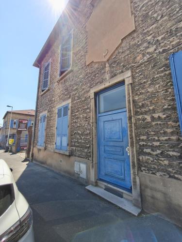 a blue door on the side of a brick building at L'Appart de Soph in Mâcon