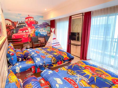 a bedroom with two beds and a room with cars beds at Pacific Palace Hotel in Nagoya