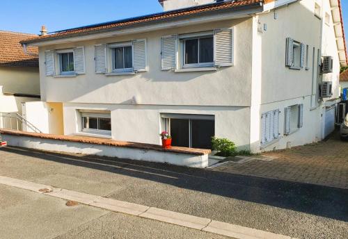 a white building with windows and a door at Proche Centre, Gare, Parc, Parking by Maison Bonhage in Chaumont