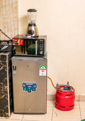 a blender sitting on top of a refrigerator at Furnished Cozy One Bedroom Apartment in Busia