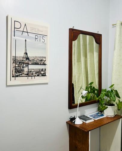 a mirror and a lamp on a table with a picture at Casa Residence by Baluyut in Concepcion