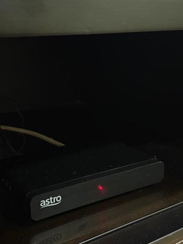 a sattomo television sitting on top of a microwave at 40 Winn's Homestay in Bentong