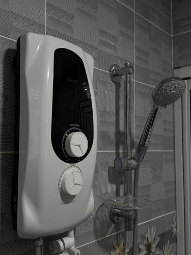 a bathroom with a urinal on the wall at 40 Winn's Homestay in Bentong