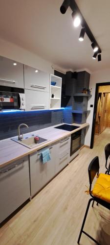 a kitchen with a sink and a counter top at Green apartament 21 in Oświęcim