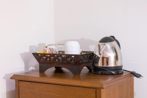 a coffee maker on top of a wooden table at Elite Home stays by UPAR, Silom in Bangkok