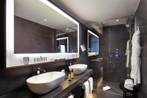 a bathroom with two sinks and a shower at ME Milan Il Duca in Milan