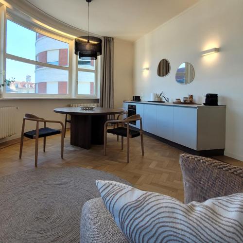 a kitchen and living room with a table and chairs at Giselda Suite - Oval in Turin