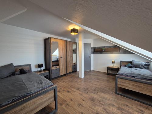 a large room with two beds and a mirror at Mikra Homes24 in Gößnitz in Gößnitz