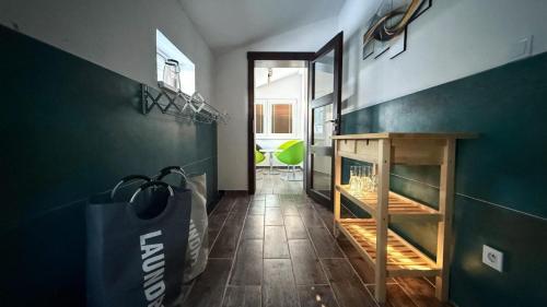 a hallway with a table and a green wall at Chalupy Severní in Lobendava