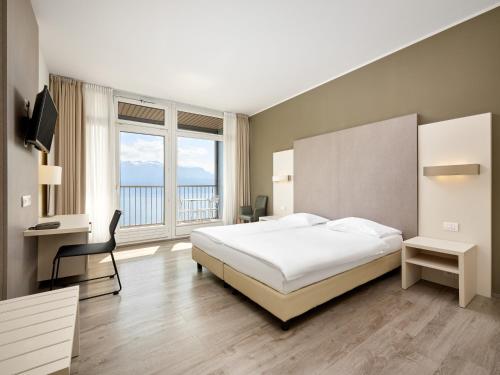 Postel nebo postele na pokoji v ubytování Hôtel Prealpina