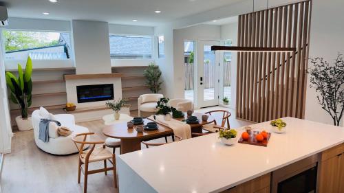 a kitchen and living room with a table and chairs at Brand New Architectural Gem 1900 sqft House with SPA bathroom 15min to downtown in Seattle