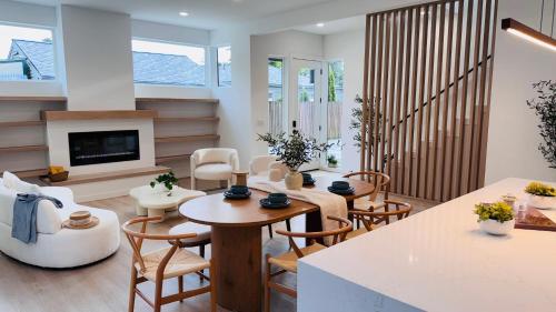 a living room with a table and chairs and a fireplace at Brand New Architectural Gem 1900 sqft House with SPA bathroom 15min to downtown in Seattle