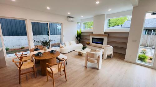 a large living room with a table and chairs at Brand New Architectural Gem 1900 sqft House with SPA bathroom 15min to downtown in Seattle