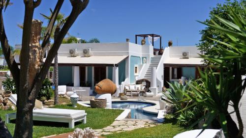 a house with a swimming pool in the yard at Hotel Oasi in Panarea