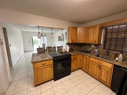 a kitchen with wooden cabinets and black appliances at 82-10SW 135AV in Miami