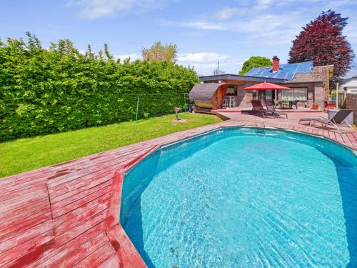 a swimming pool in the backyard of a house at Step by Stef in Bertrix
