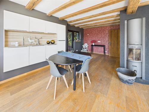 a kitchen with a dining room table and chairs at Step by Stef in Bertrix