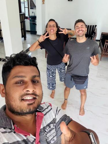 a group of three men posing for a picture at Ahasna Airport Villa in Negombo