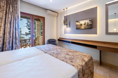 a bedroom with a bed and a window at Country Inn in Kallithea Halkidikis