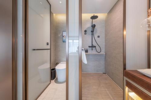a bathroom with a shower and a toilet at Atour S Hotel Beijing Daxing International Airport in Daxing