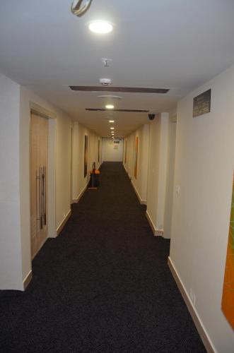an empty hallway in an office building at Maha Bodhi Hotel.Resort.Convention Centre in Bodh Gaya