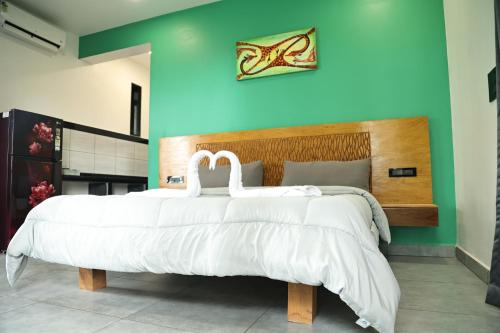 a bedroom with a large bed with white sheets at Fusion Home in Anjuna