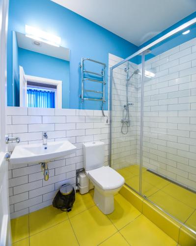 a bathroom with a toilet and a sink and a shower at Partner Guest House Baseina in Kyiv
