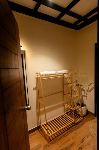 a room with a shelf in the corner of a room at Tanay Stays in Mārg Āsni