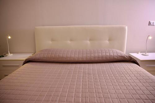 a bedroom with a bed with a pink comforter at B&B Pozzilli in Pozzilli