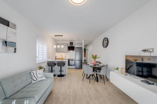 a living room and kitchen with a couch and a table at Apartman Sea in Podstrana