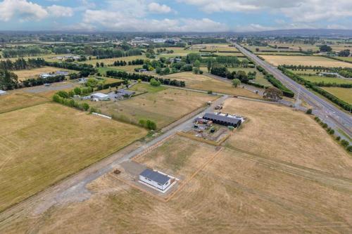 an aerial view of a field with a house at A Quiet Abode - Country Retreat in Flaxton