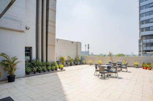 a patio with tables and chairs on a building at AR Suites KLJ Square in Gurgaon