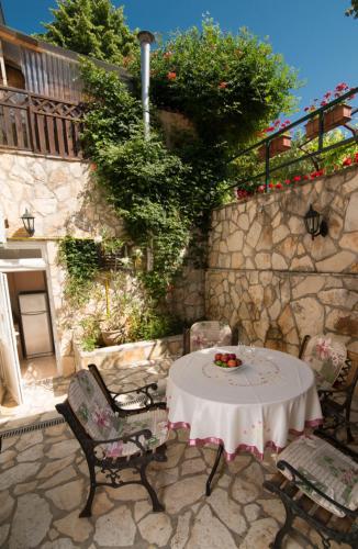 a table and chairs sitting on a stone patio at Villa Anna in Savudrija