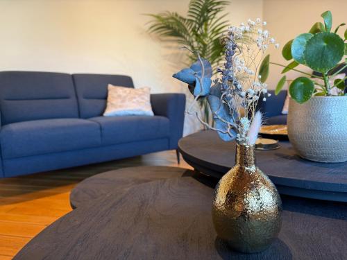 a living room with a vase with flowers on a table at Villa Luna in Oudsbergen 