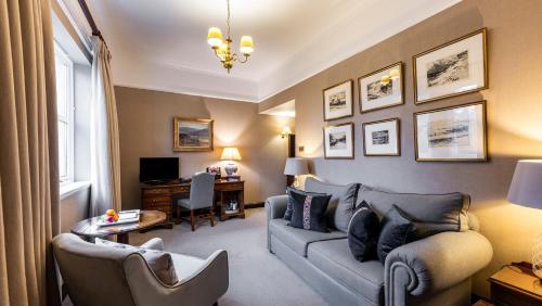 a living room with a couch and a desk at Marcliffe in Aberdeen