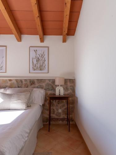 a bedroom with a bed and a table at Es Petit de Valldemossa in Valldemossa