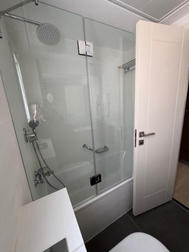 a glass shower in a bathroom with a toilet at Abratel Sea View in Tel Aviv