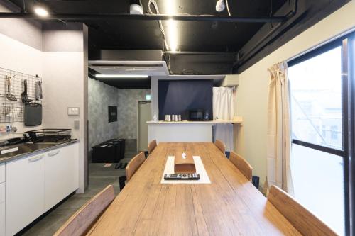 a dining room with a long table and a tv at Stay Chill Shinbashi in Tokyo