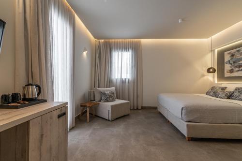 a hotel room with a bed and a chair at Kea Paradise in Korissia